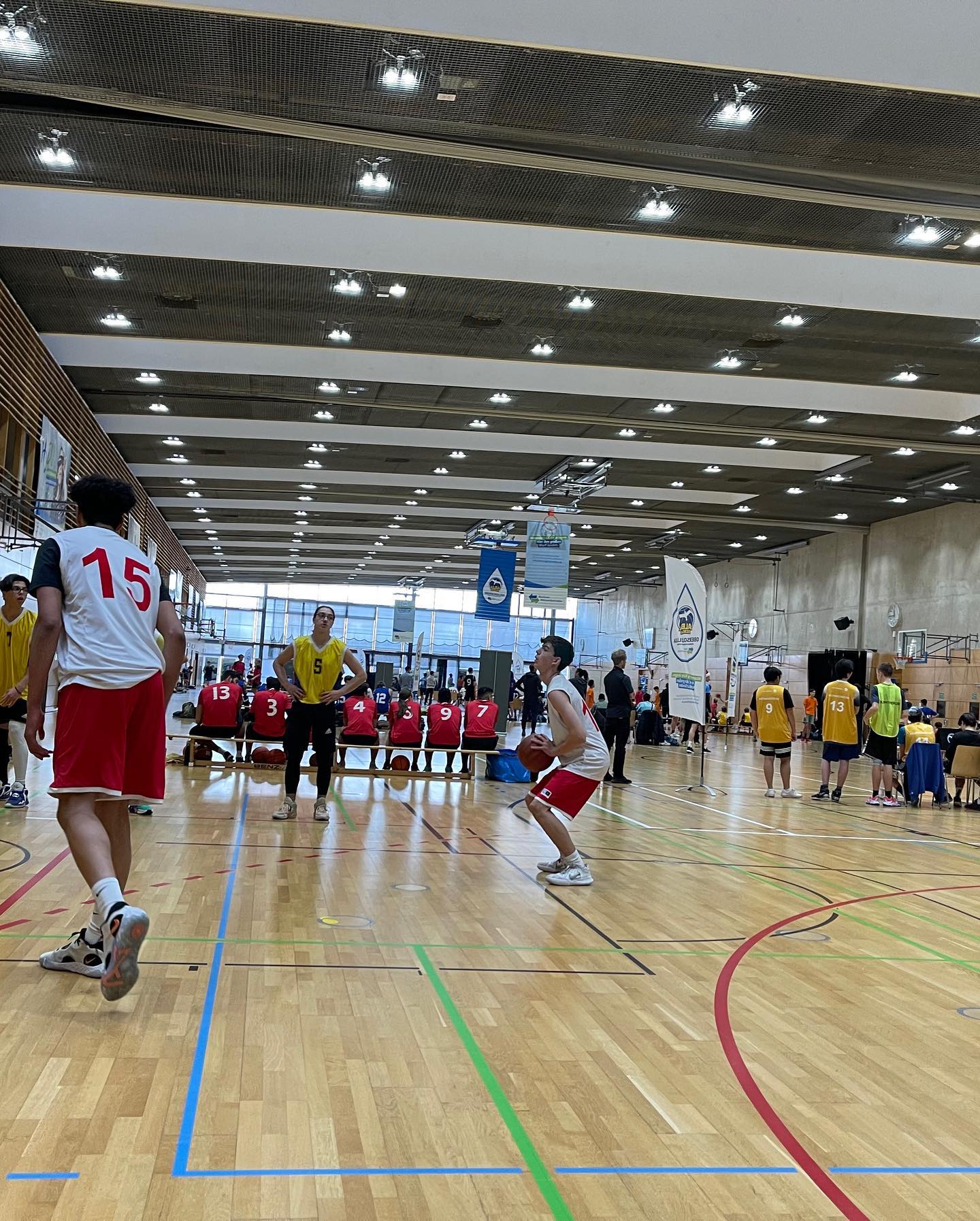 Students playing Basketball in an indoor hall