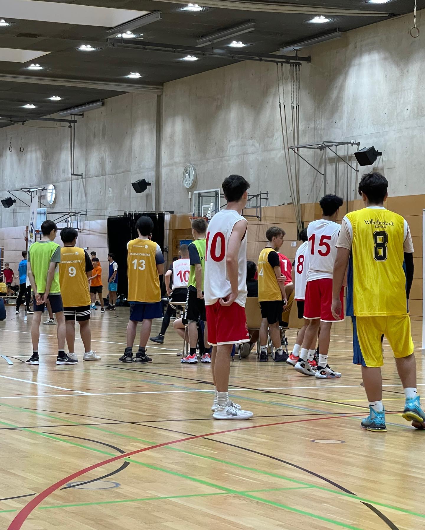 Students dressed for basketball in a sports hall